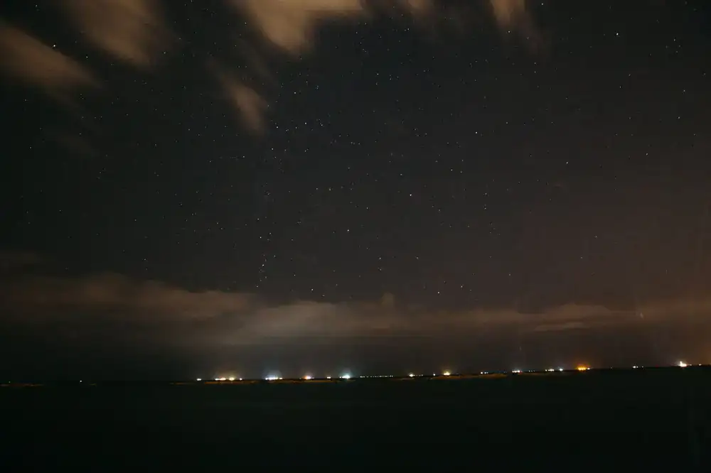 Dramatic view of the Milky Way over a dark horizon